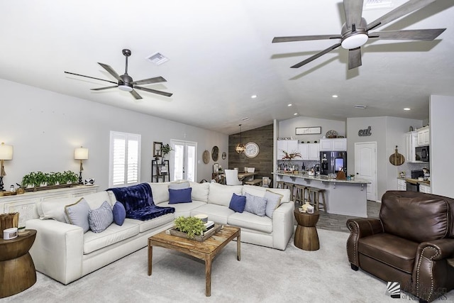 living room featuring vaulted ceiling and ceiling fan