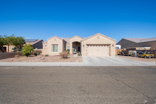 ranch-style house featuring an attached garage, a tiled roof, concrete driveway, and stucco siding