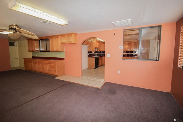 interior space featuring ceiling fan and light colored carpet