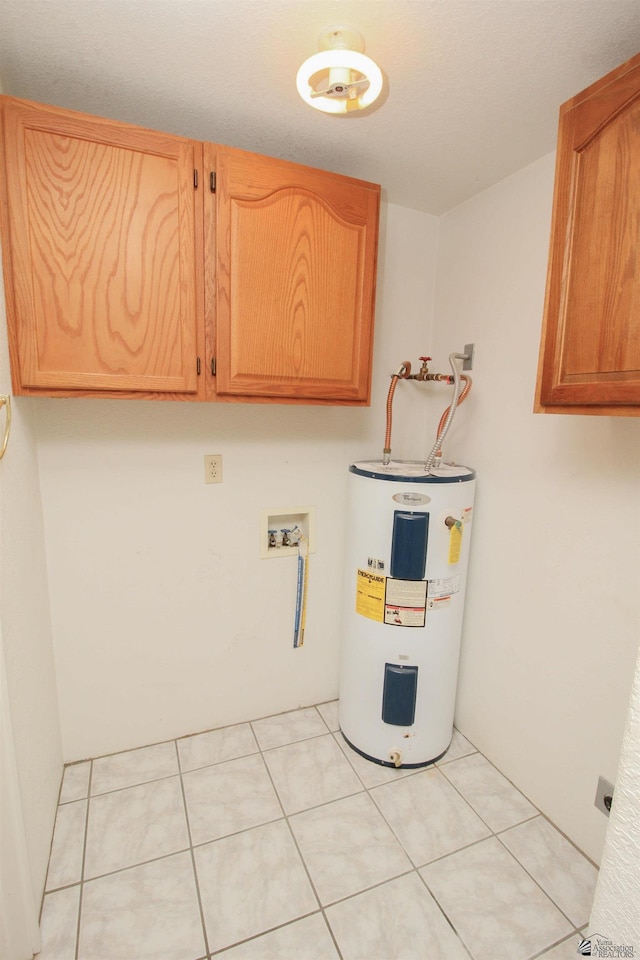 laundry room featuring washer hookup, cabinets, light tile patterned floors, and water heater