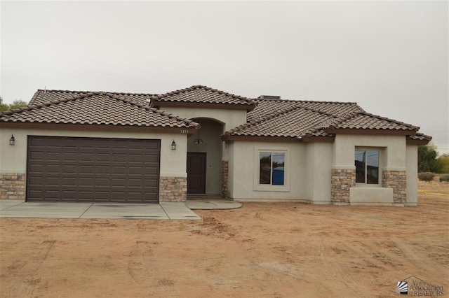 mediterranean / spanish-style house featuring a garage