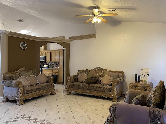 living area with lofted ceiling, light tile patterned floors, visible vents, and arched walkways