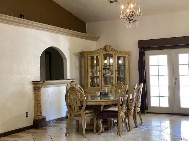 dining area featuring french doors, light tile patterned floors, lofted ceiling, an inviting chandelier, and baseboards