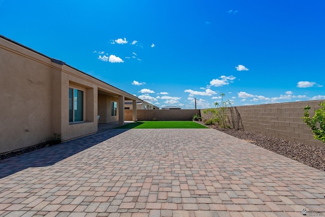 view of patio / terrace with a fenced backyard and driveway