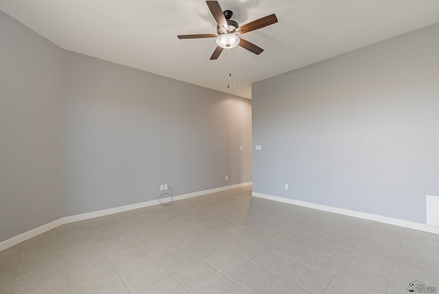 spare room with baseboards and a ceiling fan