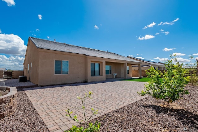 back of property featuring central air condition unit, stucco siding, a patio, and fence