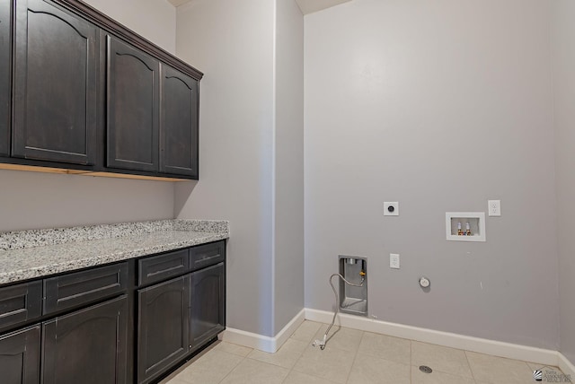 laundry area with electric dryer hookup, hookup for a gas dryer, cabinet space, light tile patterned floors, and hookup for a washing machine