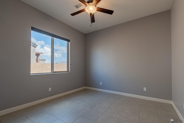 spare room with light tile patterned floors, visible vents, baseboards, and ceiling fan