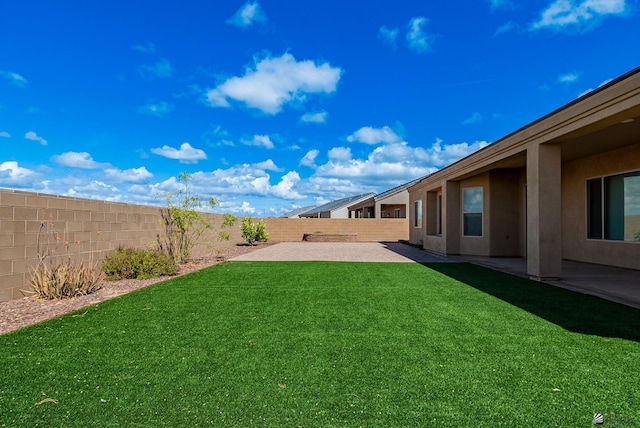 view of yard featuring a patio and a fenced backyard