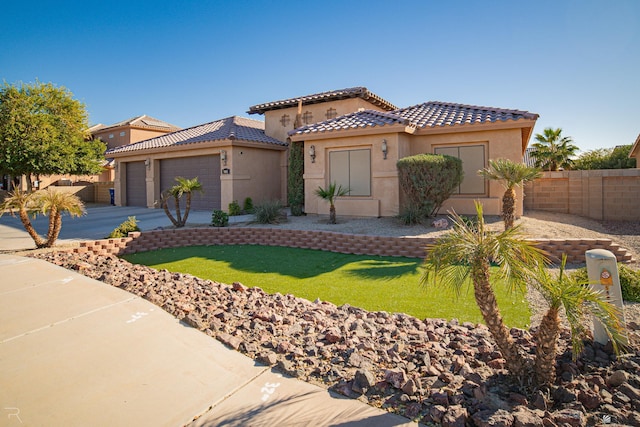 mediterranean / spanish-style house featuring a garage and a front yard