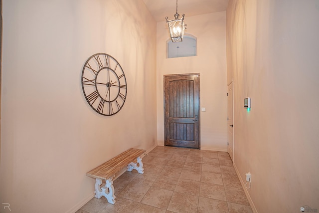 tiled foyer featuring a chandelier