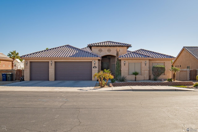 mediterranean / spanish-style house with a garage