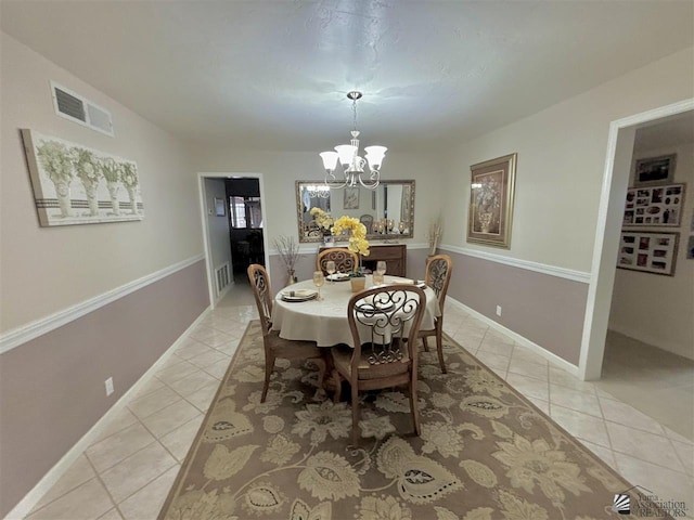 dining area featuring light tile patterned floors and a chandelier