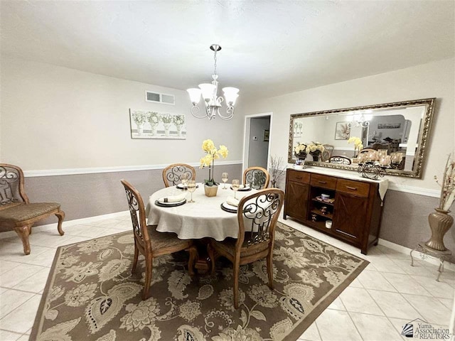 dining room featuring a notable chandelier and light tile patterned floors