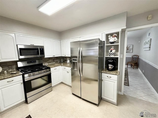 kitchen featuring white cabinets, backsplash, and stainless steel appliances