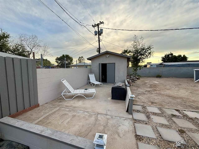 patio terrace at dusk with a storage unit