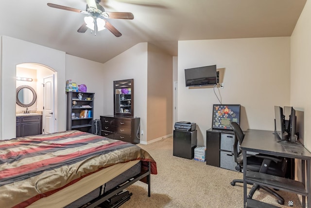 carpeted bedroom with ensuite bath, ceiling fan, sink, and lofted ceiling