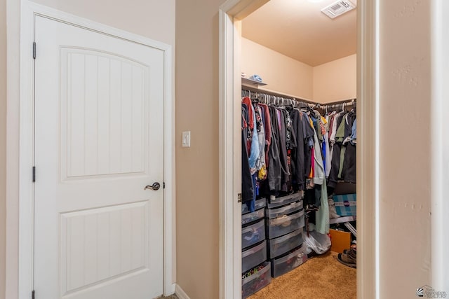 walk in closet featuring carpet