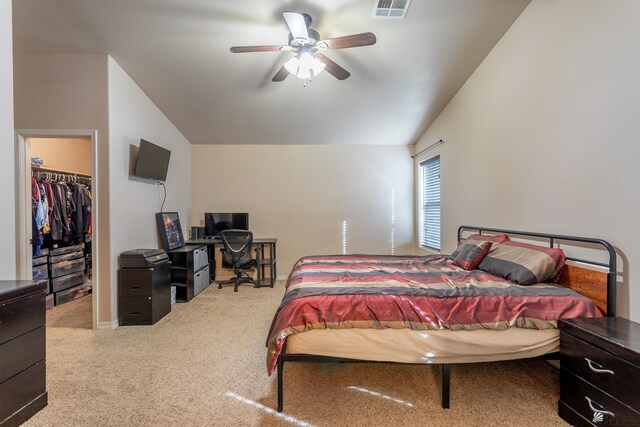 bedroom featuring a walk in closet, a closet, ceiling fan, and lofted ceiling