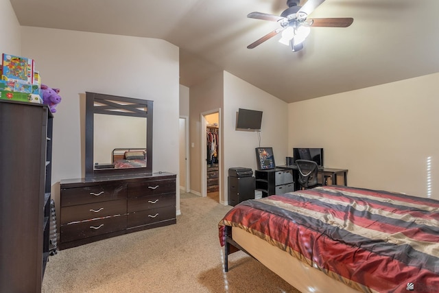 bedroom with a walk in closet, light colored carpet, ceiling fan, a closet, and lofted ceiling