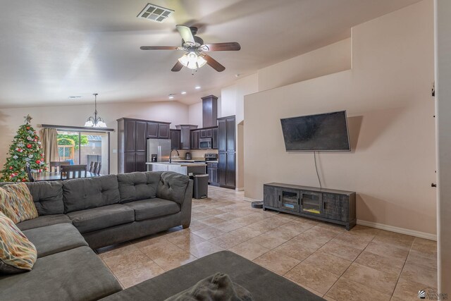 living room with light tile patterned floors, ceiling fan with notable chandelier, vaulted ceiling, and sink