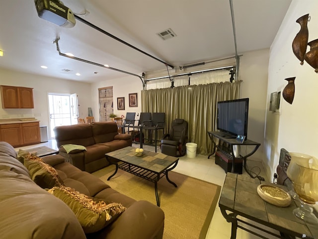 living area featuring light tile patterned floors, recessed lighting, a garage, and visible vents
