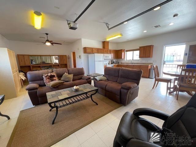 living area featuring visible vents, recessed lighting, and a ceiling fan