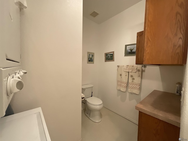 half bathroom with baseboards, visible vents, and toilet