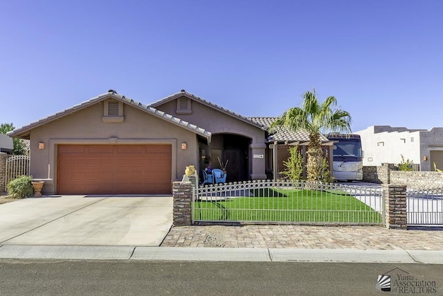 view of front of property with a garage and a front lawn