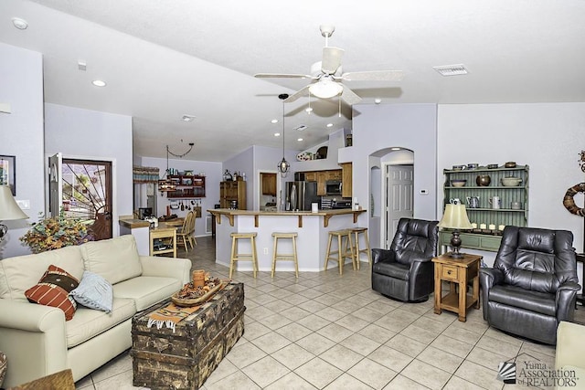 tiled living room featuring lofted ceiling and ceiling fan