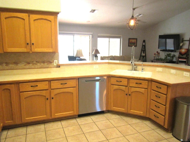 kitchen with lofted ceiling, sink, dishwasher, decorative backsplash, and kitchen peninsula