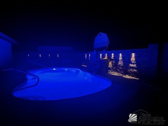 view of pool at night