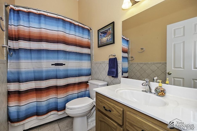 bathroom featuring tile walls, vanity, tile patterned flooring, and toilet