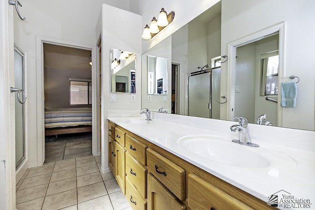 bathroom with tile patterned flooring, vanity, and a shower with shower door