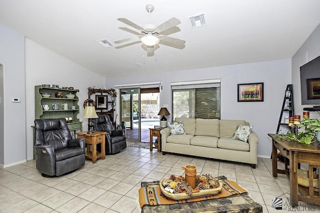 living room featuring lofted ceiling, light tile patterned floors, and ceiling fan