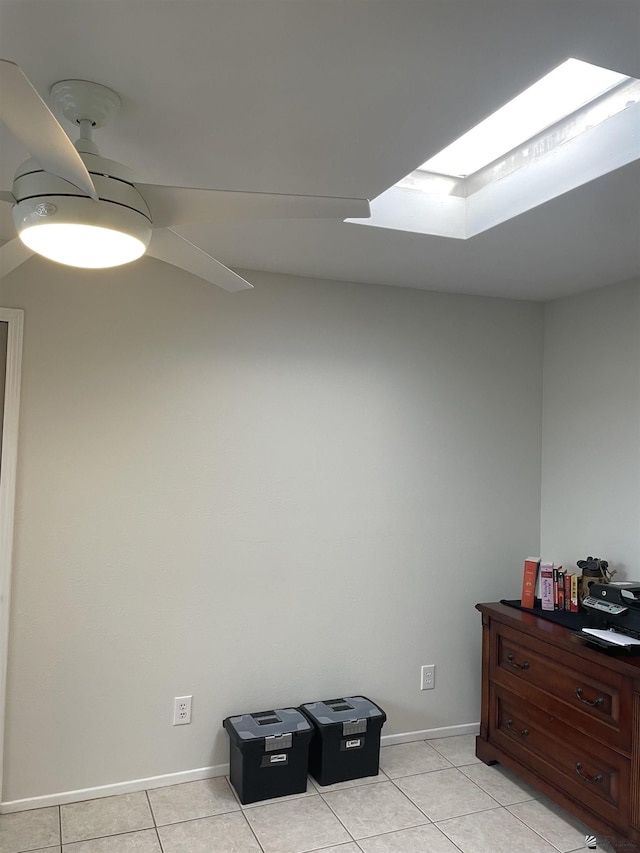 misc room with light tile patterned floors and a skylight