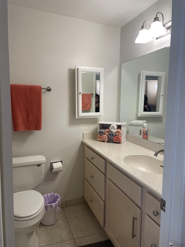 bathroom with tile patterned floors, vanity, and toilet