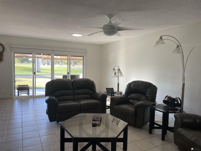 tiled living room with a textured ceiling and ceiling fan