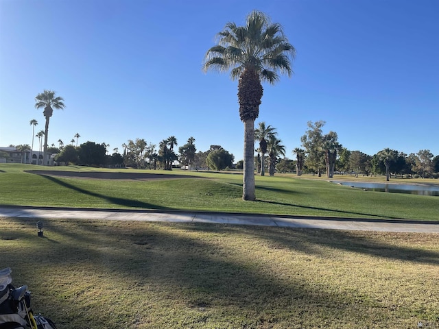 view of home's community featuring a water view and a lawn