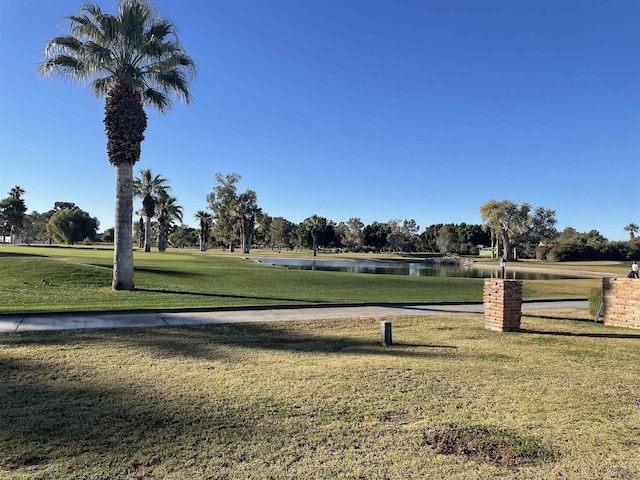 surrounding community featuring a yard and a water view