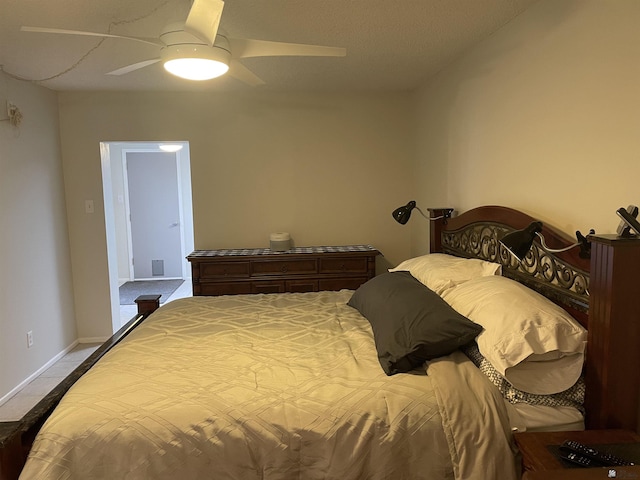 bedroom with ceiling fan and light tile patterned floors