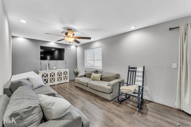 living room featuring ceiling fan and hardwood / wood-style floors