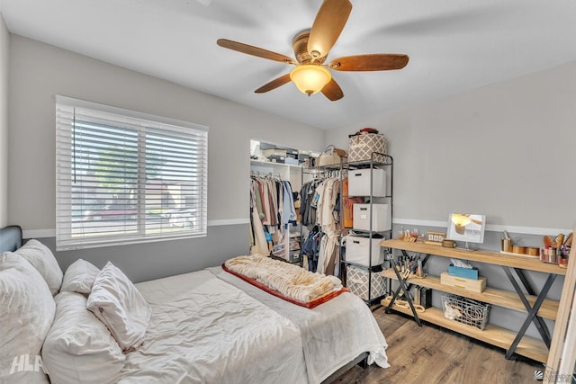 bedroom with hardwood / wood-style flooring, ceiling fan, and a closet