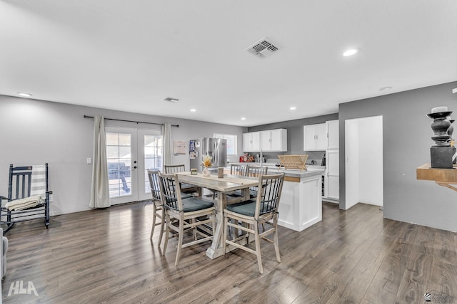 dining area with dark wood-type flooring and french doors