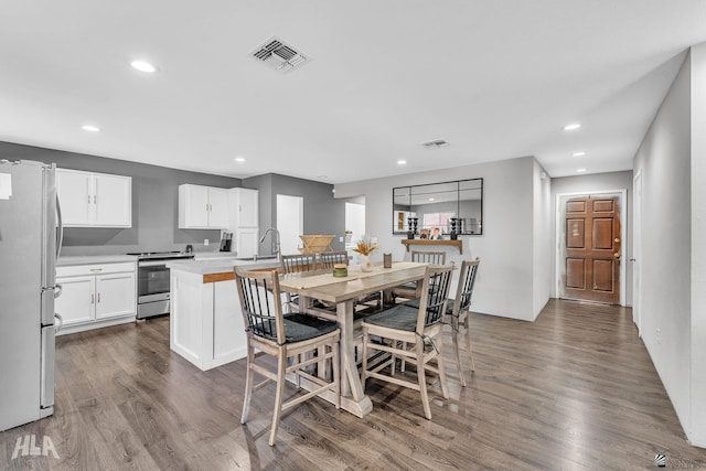 dining area with dark hardwood / wood-style flooring and sink