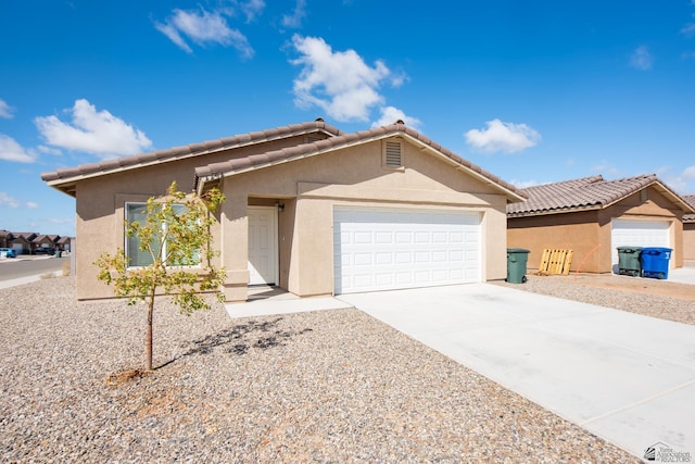 single story home with a tiled roof, a garage, driveway, and stucco siding