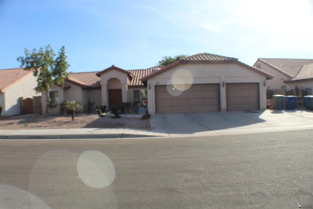 mediterranean / spanish-style house with a garage