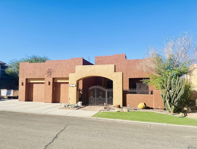 pueblo-style house featuring a garage