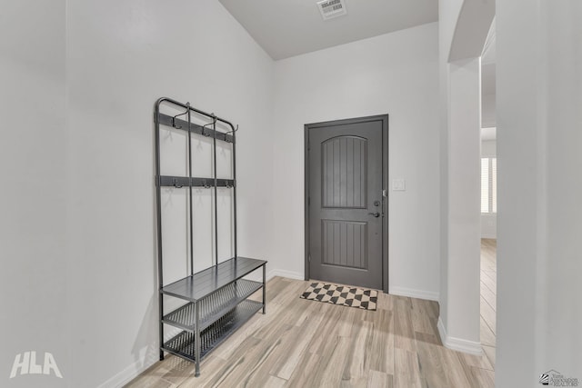 mudroom with light wood-style floors, baseboards, and visible vents