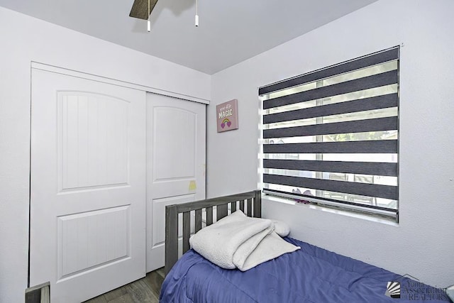 bedroom with ceiling fan, a closet, and wood finished floors